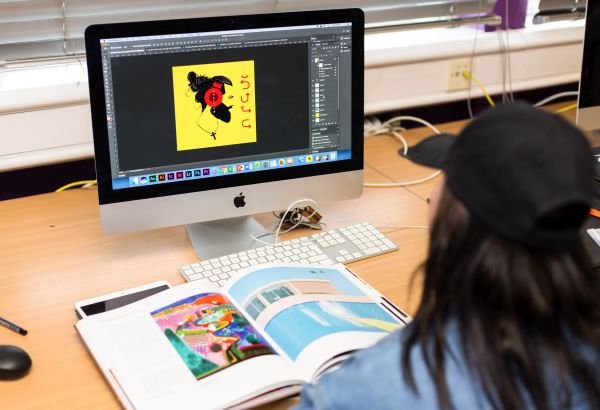 Graphic student designing on their computer