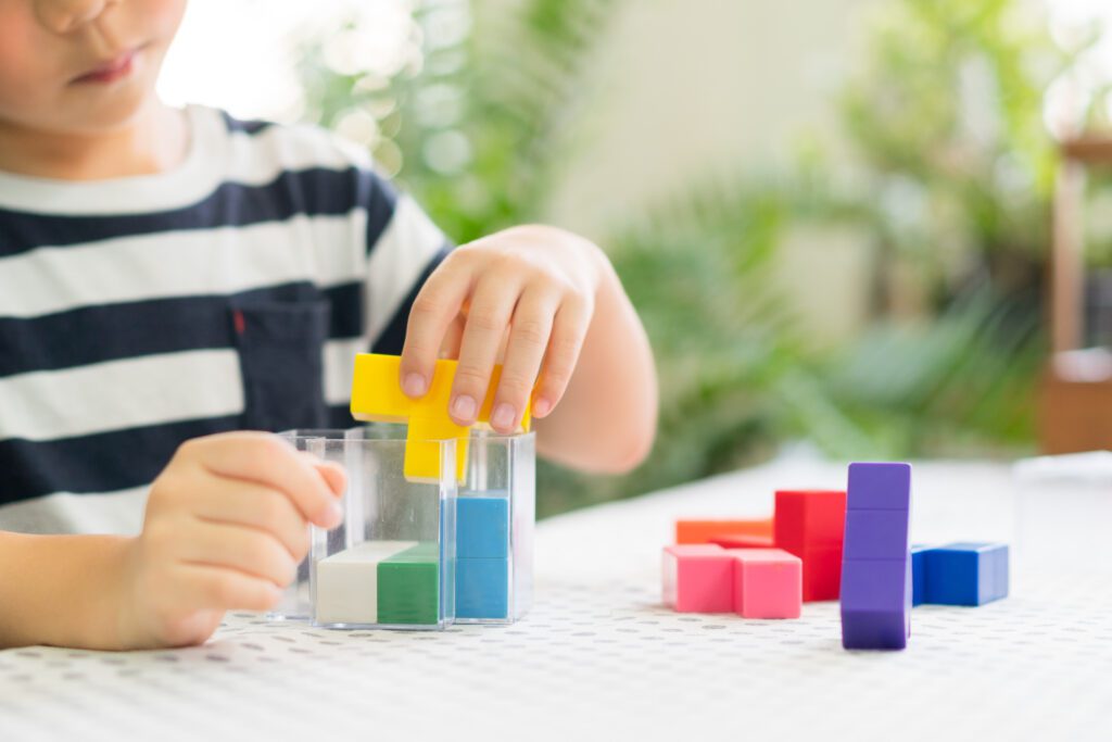 Young child plays with colourful blocks