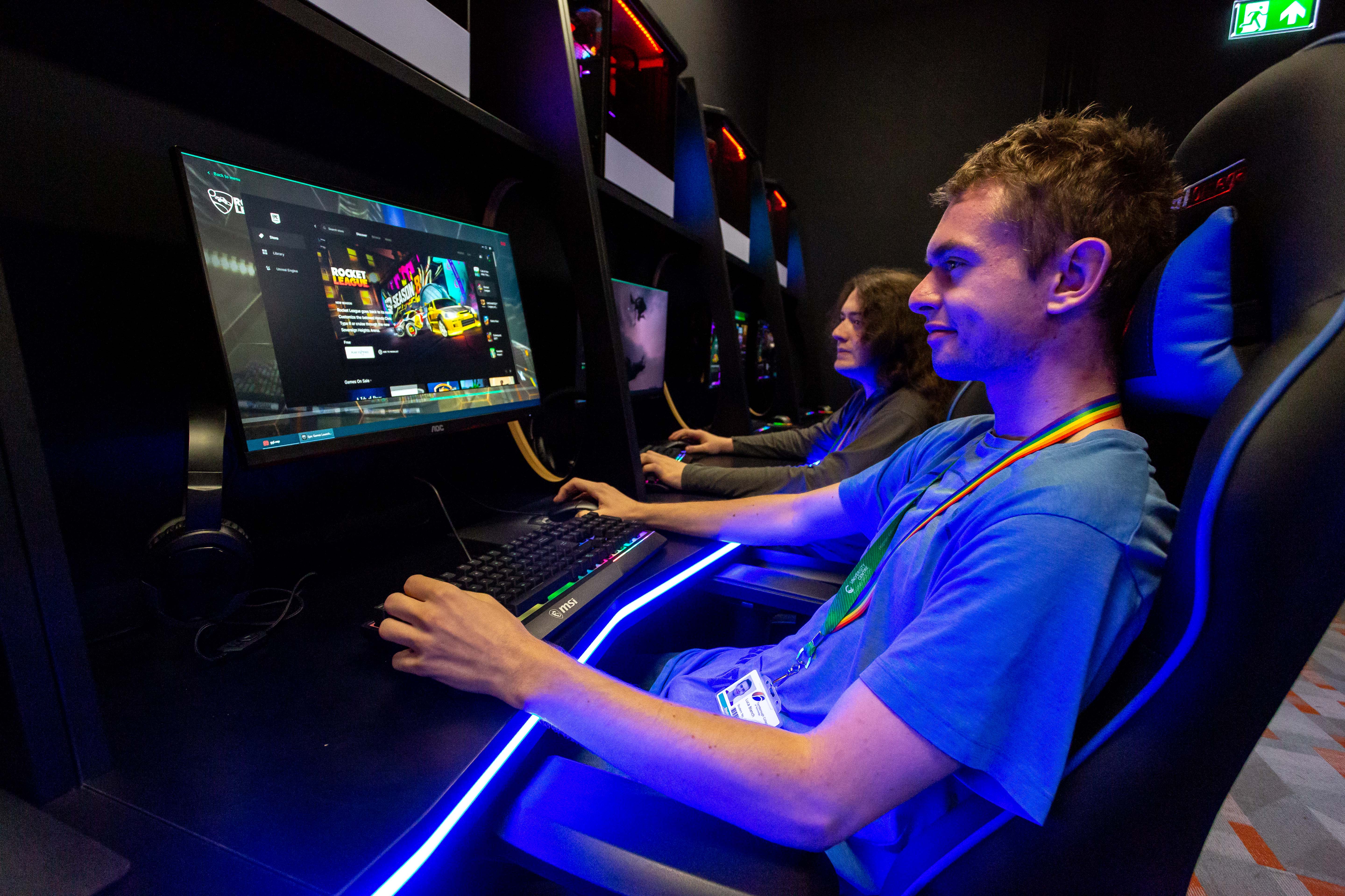 Gaming student by a computer in esports suite