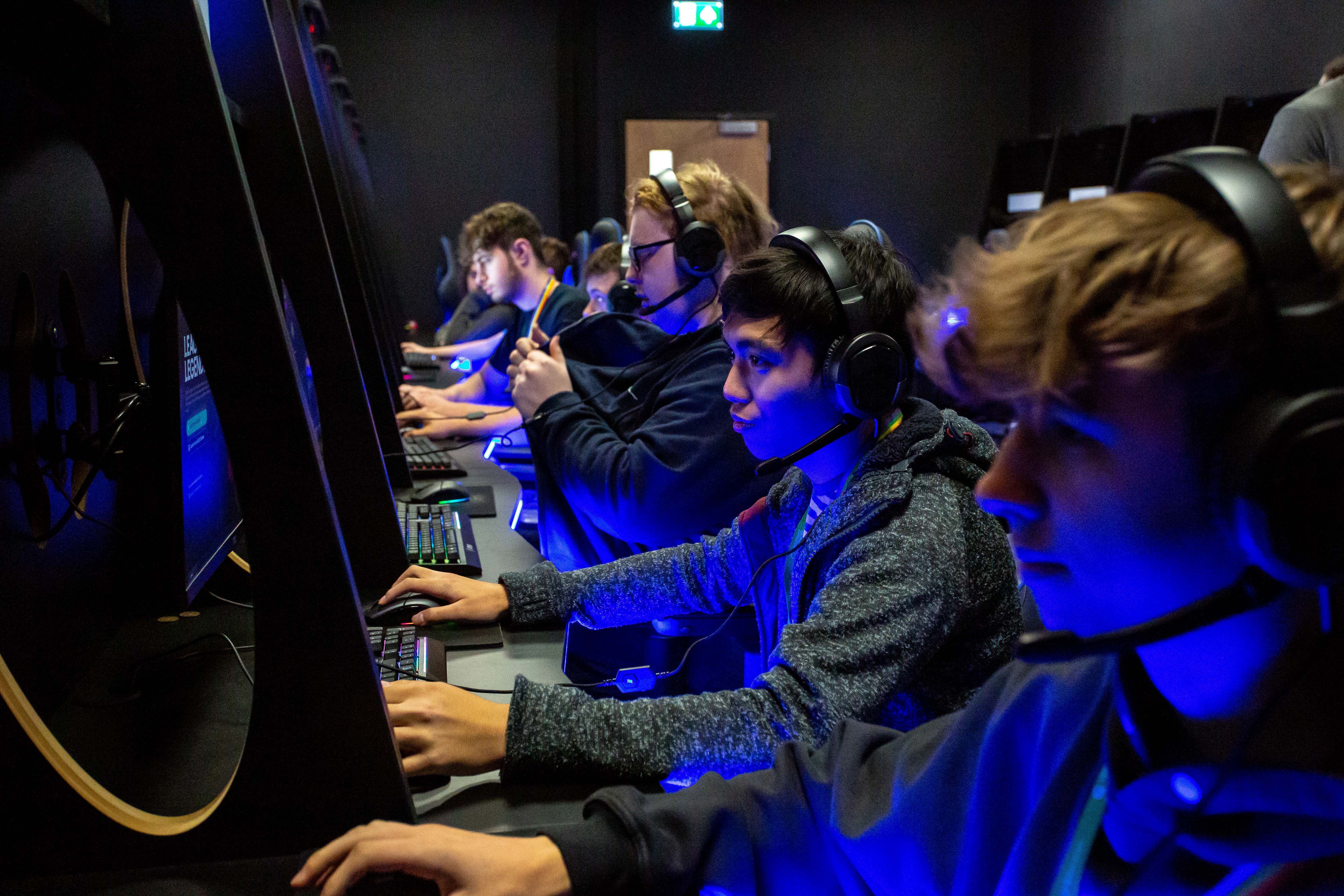 Gaming students competing on computers in esports suite